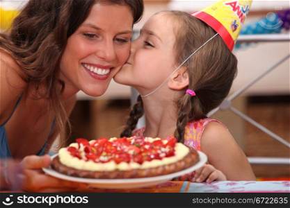 Daughter kissing mommy at birthday party