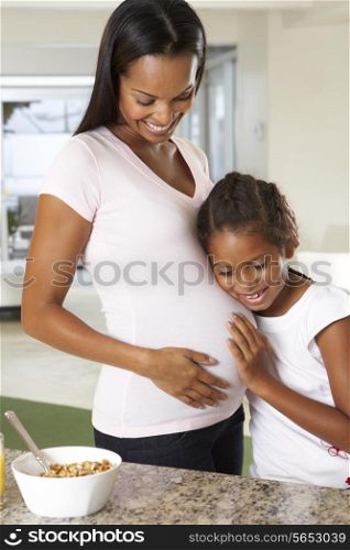 Daughter Listening To Pregnant Mother&#39;s Stomach