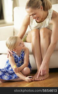 Daughter Painting Mother&#39;s Toenails At Home