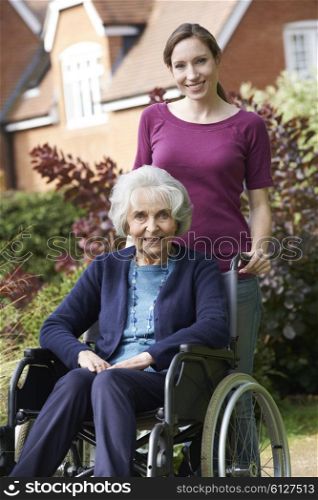 Daughter Pushing Senior Mother In Wheelchair