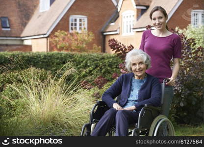 Daughter Pushing Senior Mother In Wheelchair