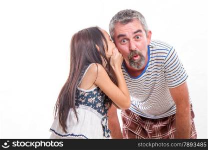 Daughter telling dad a secret, whispering in his ear