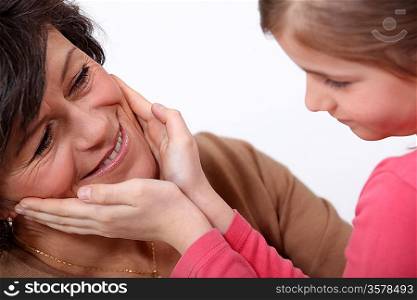Daughter touching mother&acute;s face