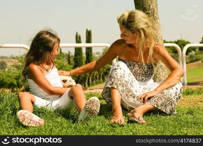 Daughter with mother enjoying at picnic