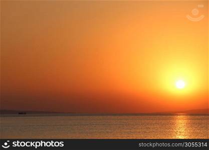 Dawn above sea. Beautiful summer Dawn above ocean. Beautiful blazing sunset landscape above Red sea and orange sky in early morning. Amazing summer dawn. Sunny trace. Dawn above sea. Beautiful summer Dawn above ocean