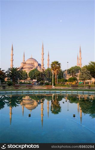 Dawn at the Blue Mosque (Sultan Ahmet Camii) with reflection on water in Sultanahmet district, city of Istanbul, Turkey.