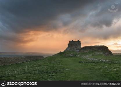 Dawn breaks over Lindisfarne Castle on Holy Island Northumberland