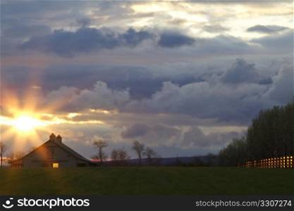 Dawn highlights a country barn, without and within, as well as a sturdy fence line with its emergent light. Copy space.