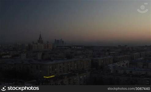 Dawn in the city from high point of view. Time lapse with panning.