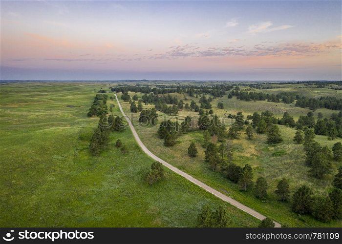 dawn over sandy road in Nebraska National Forest, aerial view