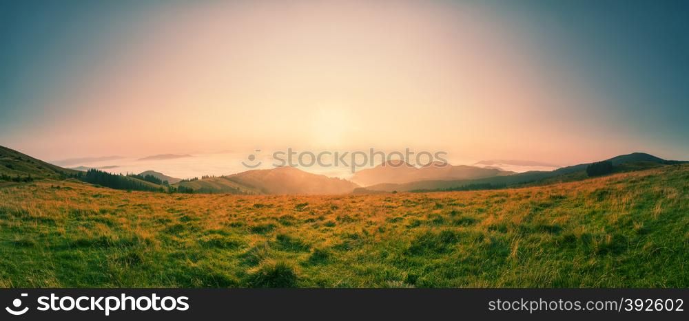 Dawn over the tops of the mountains. Summer landscape. Panorama.. Dawn over the tops of the mountains
