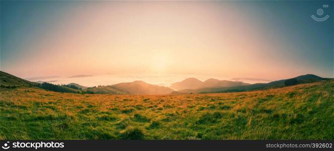 Dawn over the tops of the mountains. Summer landscape. Panorama.. Dawn over the tops of the mountains