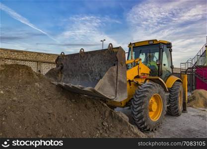 day view of yellow excavator with shovel at construction site