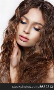 Daydreaming Brunette with Curly Hair and Blue Eyeshadows