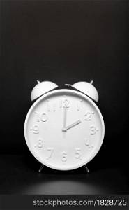 Daylight saving time concept. White Retro clock isolated on black background. Copy space