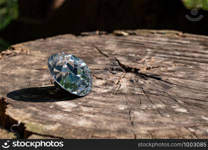 Dazzling round diamond at wood background