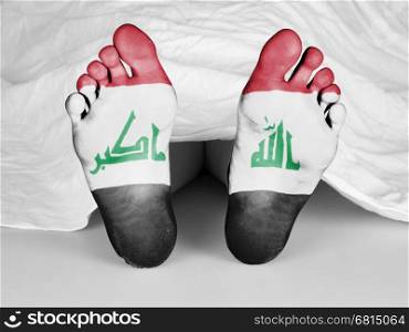 Dead body under a white sheet, flag of Iraq