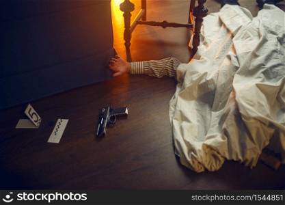 Dead man, victim and murder weapon, evidence at the crime scene, retro style. Criminal investigation, inspector is working on a murder, vintage room interior on background. Dead man, victim and murder weapon, crime scene
