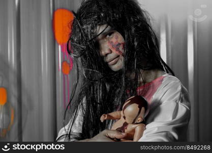 Dead patient with bloody doll in a scary dark room. Horror Halloween concept