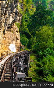Dead railway beside cliff, along Kwai river in Thailand