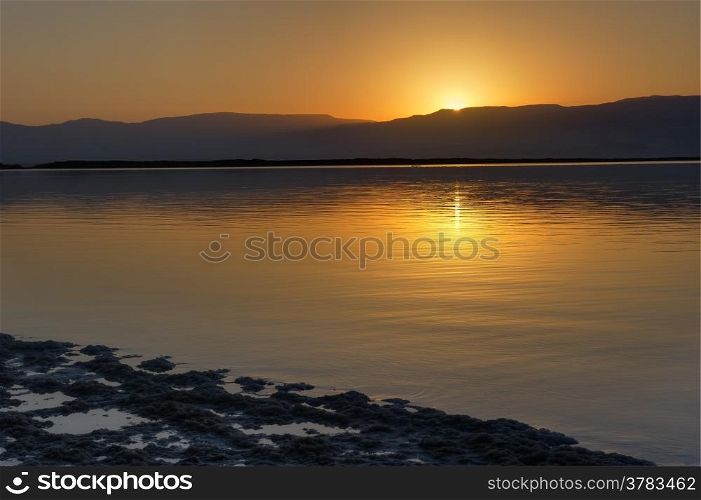 Dead Sea at dawn and the first ray of sun that has risen over the Jordanian mountains.