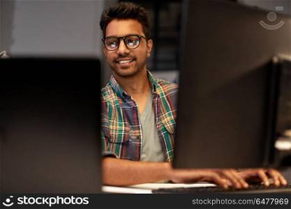 deadline, technology and people concept - close up of creative man in glasses working at night office and thinking. close up of creative man working at night office. close up of creative man working at night office