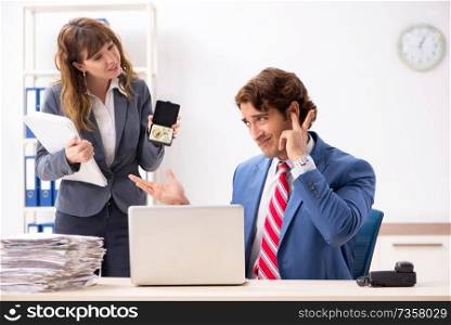 Deaf employee using hearing aid talking to boss
