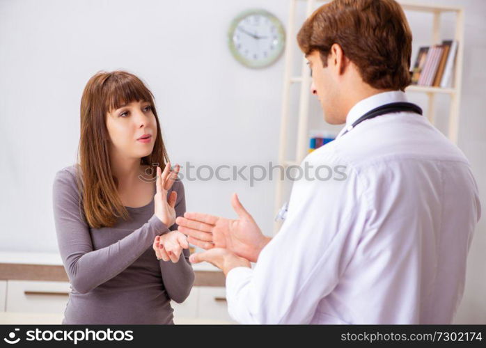 Deaf-mute female patient visiting young male doctor