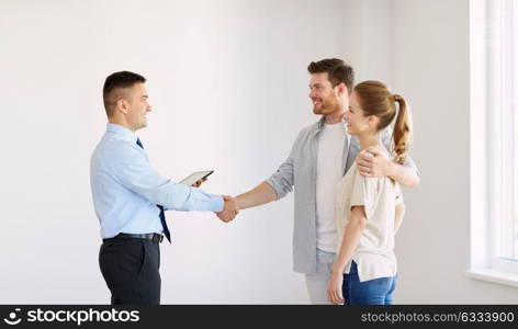 deal, people and real estate concept - happy couple and realtor with tablet pc computer shaking hands at new home. man and realtor shaking hands at new home