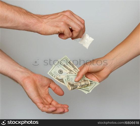 Dealer (man) selling cocaine drugs bag to a paying woman, isolated on white