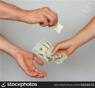 Dealer (man) selling cocaine drugs bag to a paying woman, isolated on white