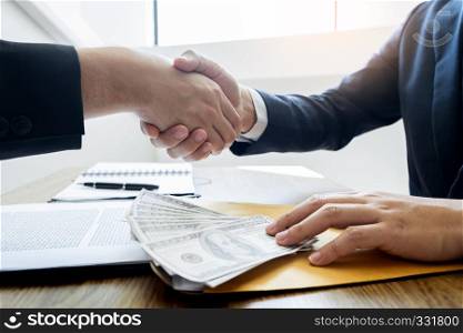 Dealing greeting and partnership meeting concept, businessmen handshaking after finishing up deal contract for both companies
