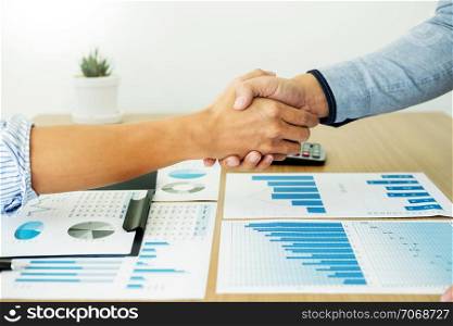 Dealing greeting and partnership meeting concept, businessmen handshaking after finishing up deal contract for both companies