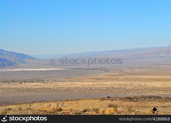Death Valley desert landscape receding into haze.