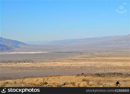Death Valley desert landscape receding into haze.