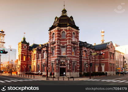 DEC 2, 2018 Iwate, Japan - Red brick building classic old Bank of Iwate in Morioka city at evening with sunset light. Iconic land mark with people walking on street - Tohoku region beautiful landscape and city