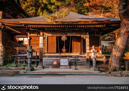 DEC 3, 2018 Yamagata, Japan - Nenbutsu hall old wooden building buddha shrine under evening light and pine tree in Yamadera Risshaku ji temple