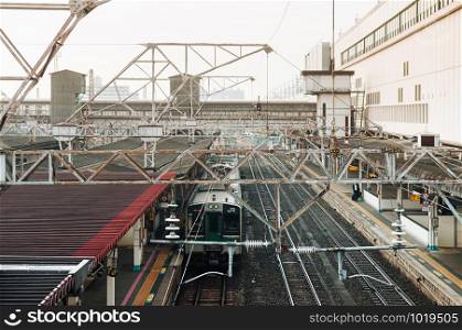 DEC 4, 2018 Koriyama, JAPAN - JR Commuter train stop at Koriyama station. Aerial view image with metal truss and high voltage electric wires system
