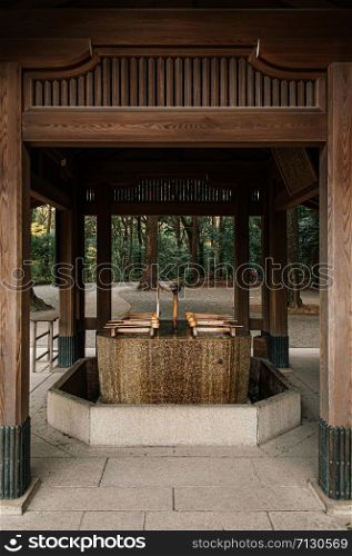 DEC 5, 2018 Tokyo, Japan - Meiji Jingu Shrine Historic Wooden Temizuya or sacred water pavilion - Most important shrine and city green space of Japan capital city.