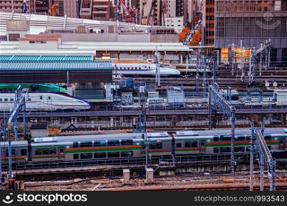 DEC 6, 2019 Tokyo, Japan - Tokyo Station JR train in motion and Shinkansen tracks from aerial view. Train traffic at Tokyo station in evening