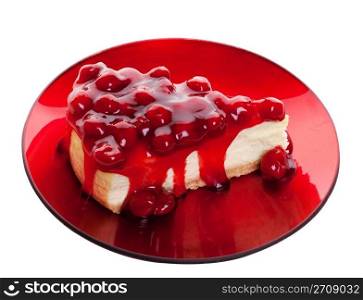 Decadent cherry cheesecake served on a candy apple red plate. Shot on white background.