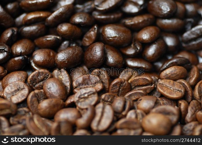 Decaffinated and caffinated coffee beans piled next to each other.