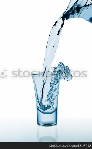 Decanter and glass with water splashes. Isolated on white background