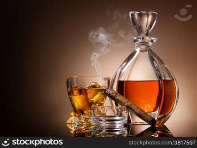 Decanter of whiskey with cigar and glass
