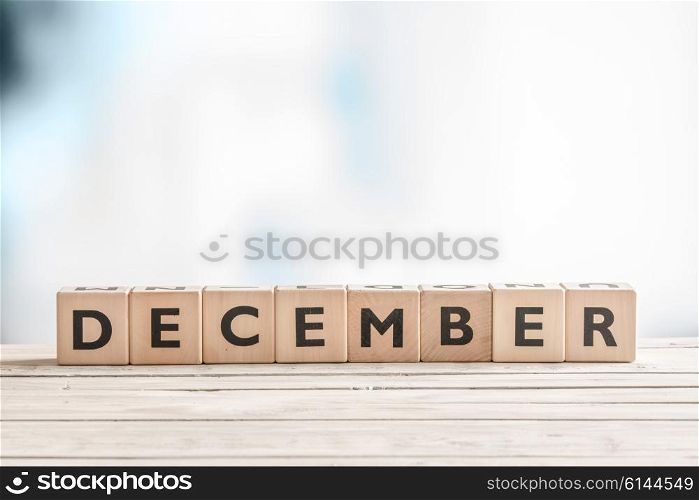 December label made of wooden cubes on a table