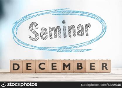 December seminar sign on a stage made of wood