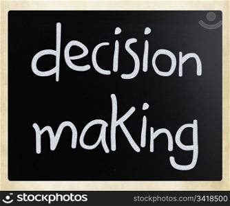 ""Decision making" handwritten with white chalk on a blackboard"