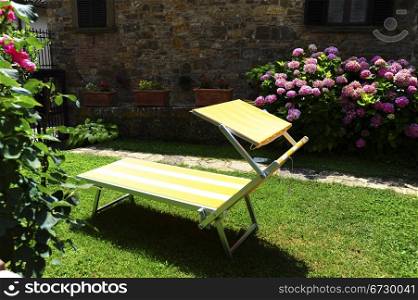 Deck Chair Standing In The Courtyard Of an Italian Home