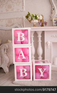 decor for photo shoots for a baby girl&rsquo;s birthday, boxes with pink balloons inside, interior, on the carpet. decorative boxes with pink balloons