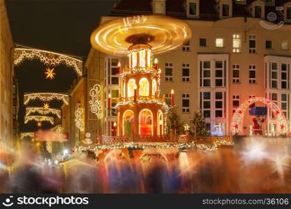Decorated and illuminated Christmas street with carousel at night in Dresden, Saxony, Germany